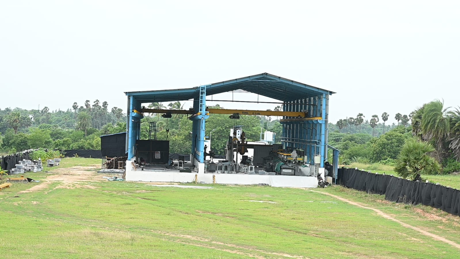 Skilled craftsmen working on granite monument in modern workshop